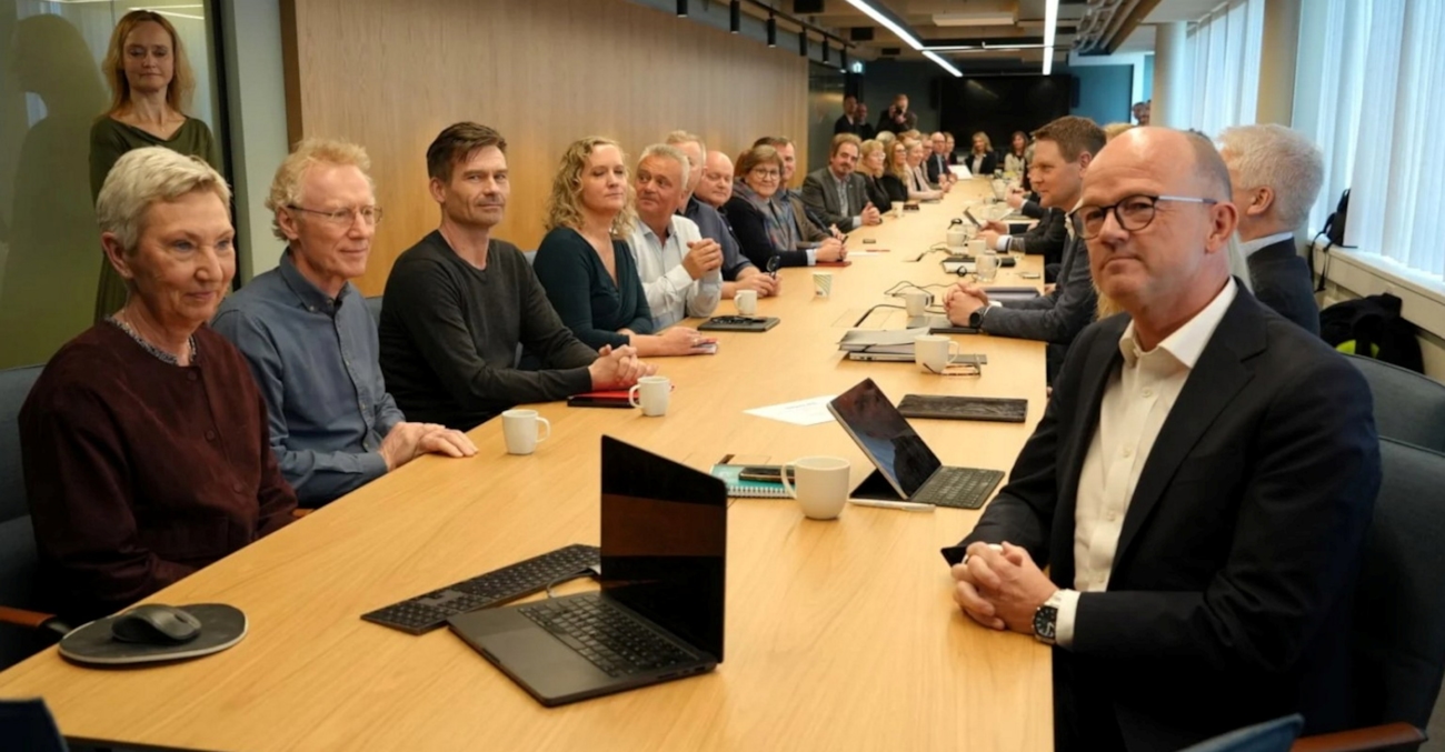 En gruppe mennesker rundt et langbord.
